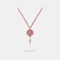 Rose-toned chain set with pink stones leading to a round tiered floral medallion pendant with a central pink stone and a tapered drop.