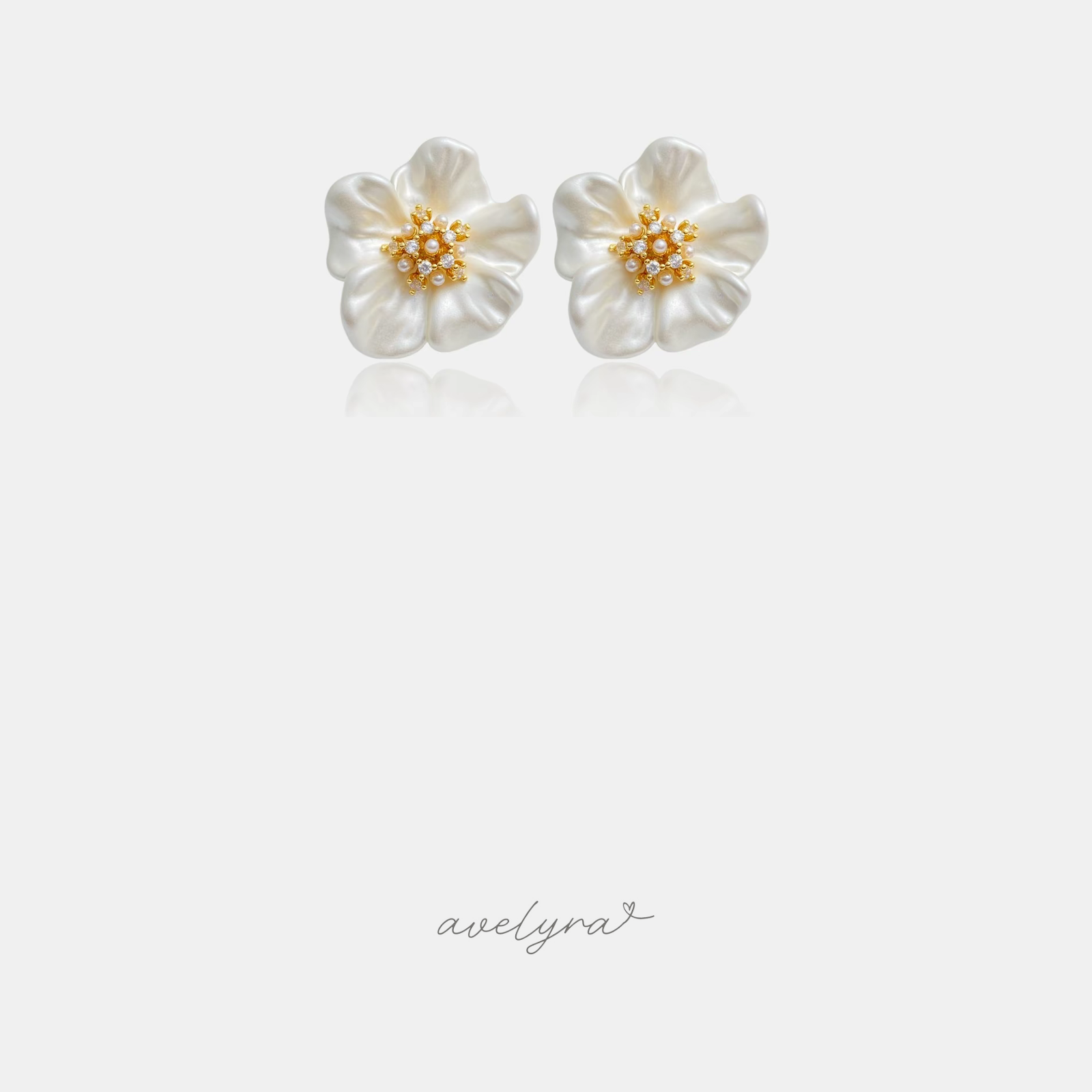 Pair of ivory flower stud earrings with a golden centre of small pearls and crystals.
