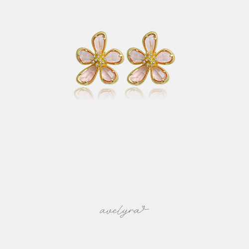 Pink five-petal flower stud earrings with gold-tone outlines and clustered crystals at the centre.