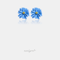 Blue daisy flower stud earrings with layered petals and a small golden centre.
