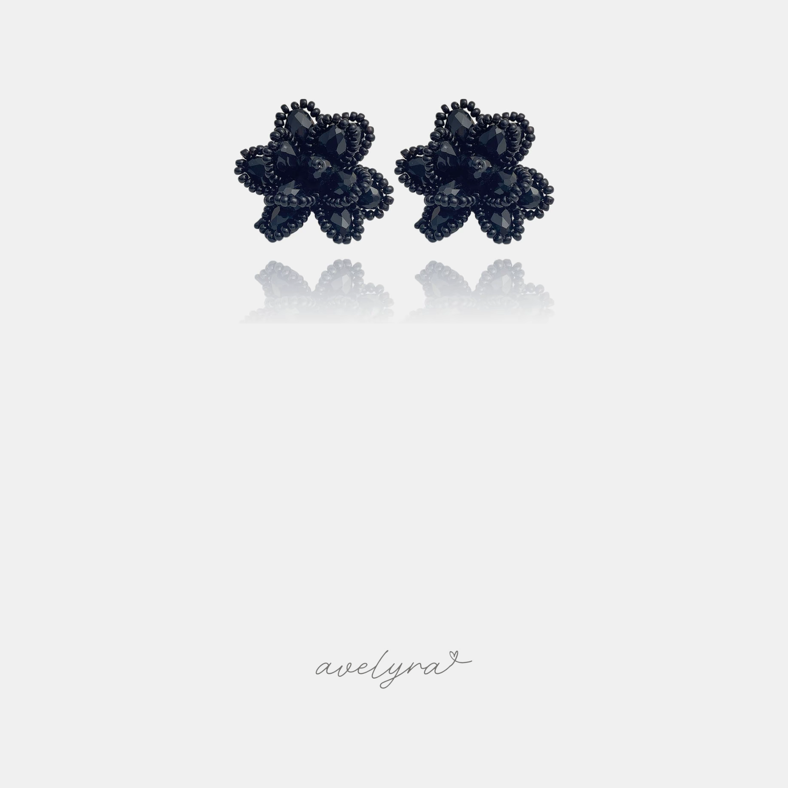Black beaded flower-shaped stud earrings with five faceted petals.