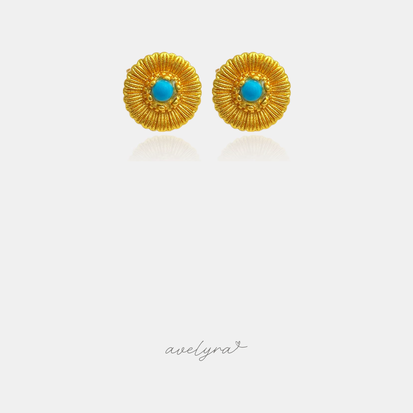 Gold-tone textured sunflower stud earrings with a light blue round centre stone.
