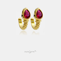 Gold-tone huggie earrings with faceted crimson-pink pear-shaped stone and rope-textured band.