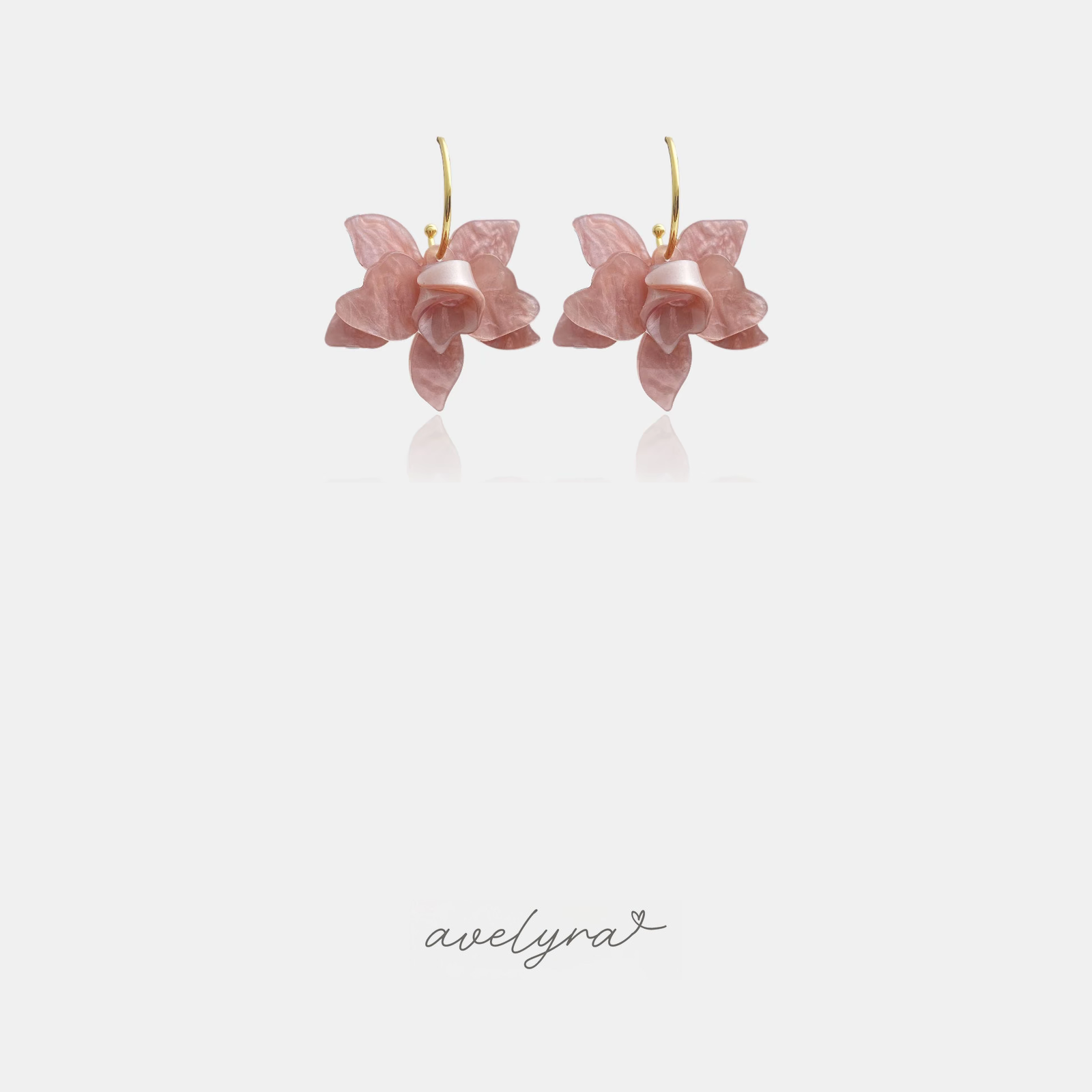 Gold-tone hoop earrings with a pearlescent blush-pink orchid flower