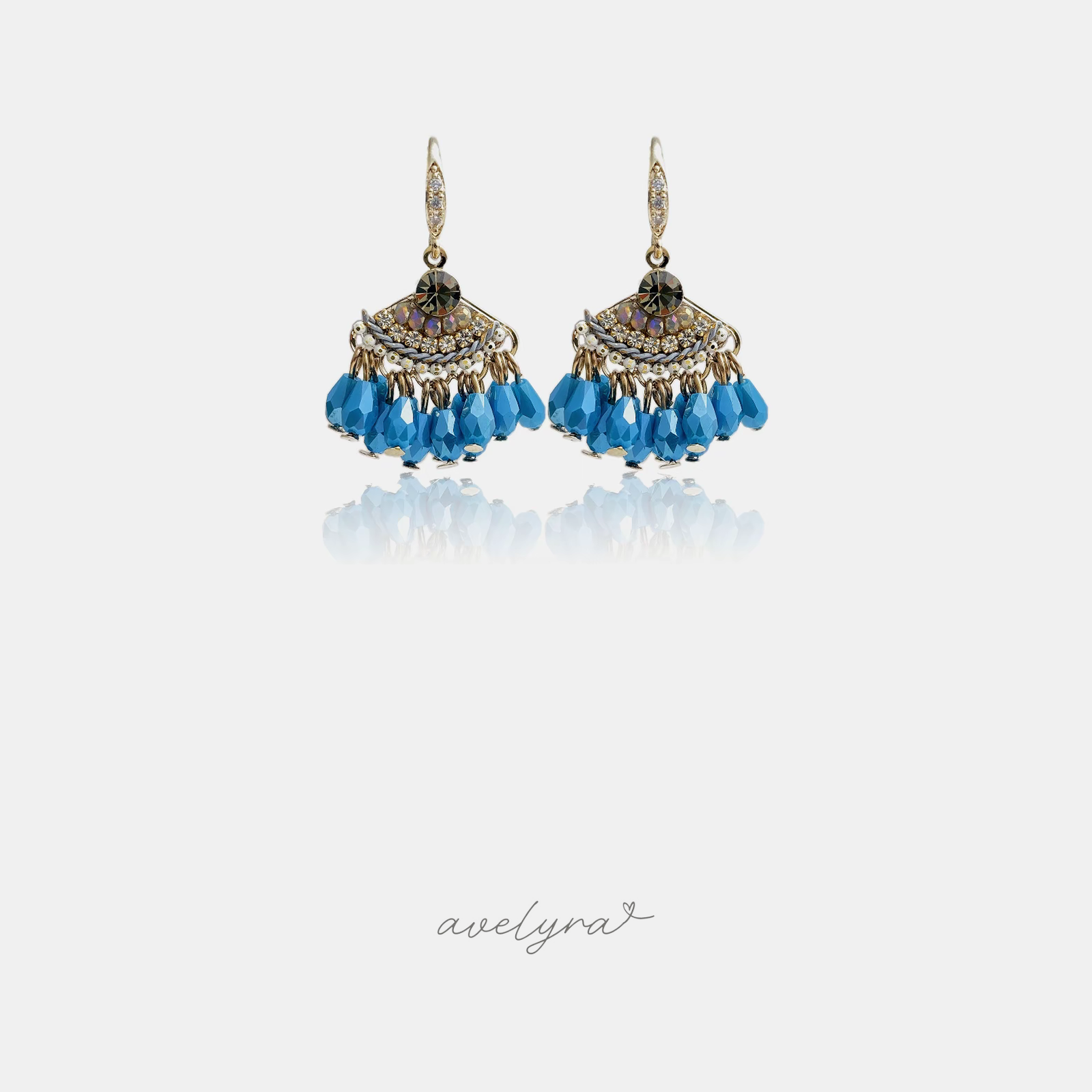 Gold-tone hook earrings with pave-set tops and clusters of blue faceted teardrop beads.