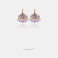 Gold-tone hook earrings with a crystal crest above a fringe of lilac beads.