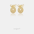 Gold bow earrings above an open woven-mesh oval drop.