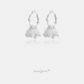 Pair of silver-tone hoop earrings with a cluster of milky white bell-shaped beads and small clear accent stones.