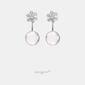 Silver-tone snowflake stud earrings with a clear round drop below.