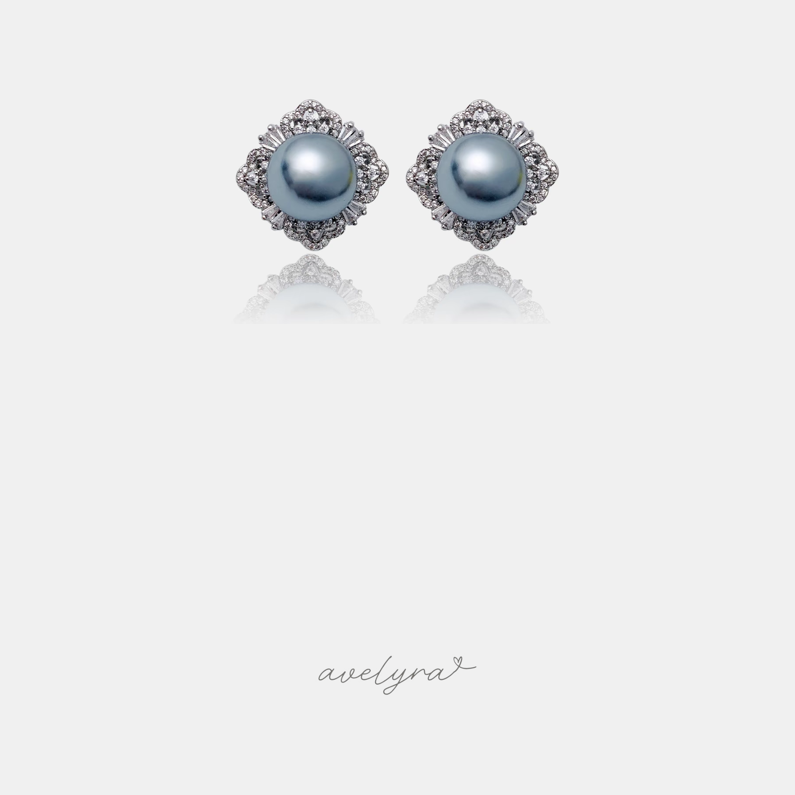 Pair of stud earrings with grey pearls surrounded by a scalloped crystal halo.