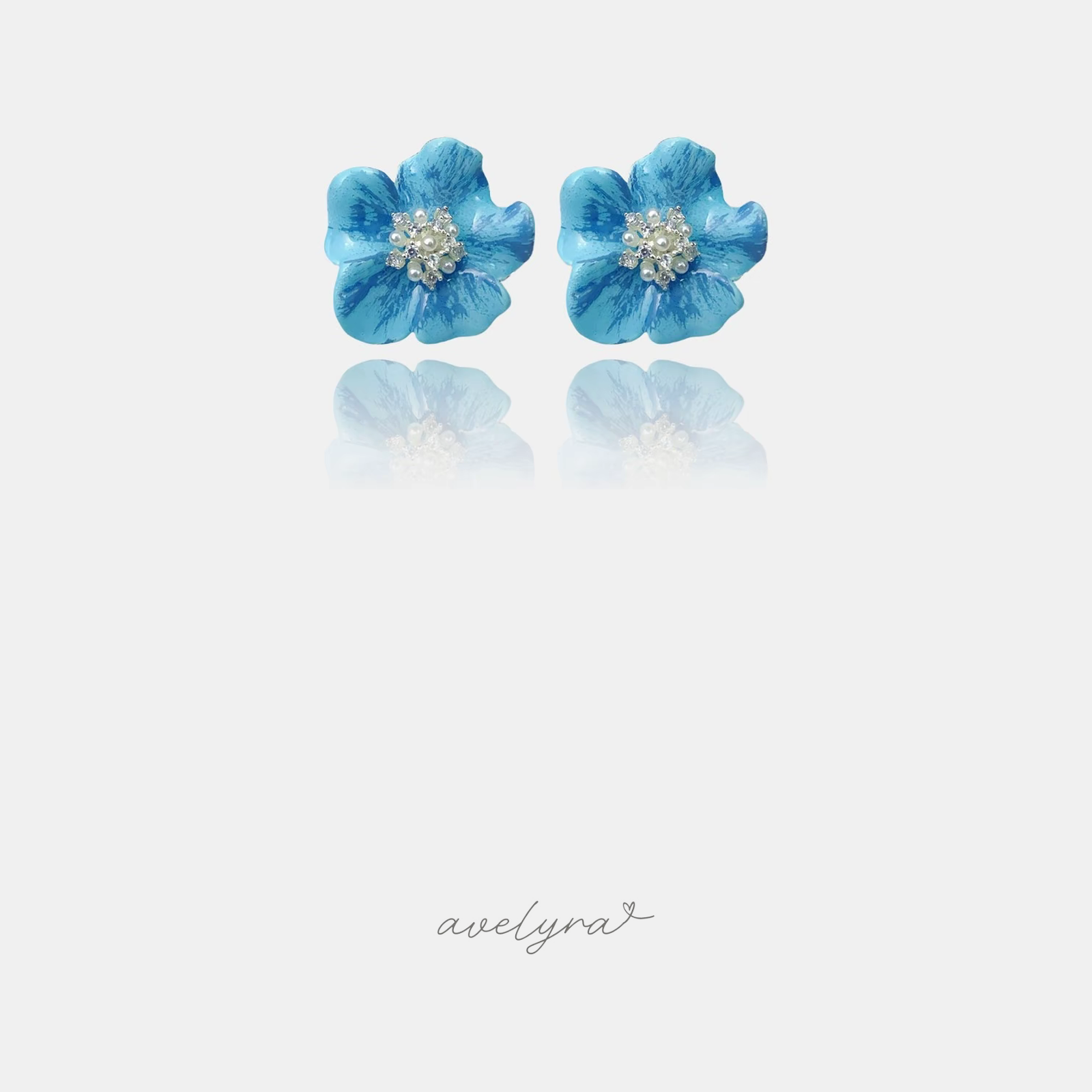 Sky-blue painted flower stud earrings with a cluster of pearls and crystals at the centre
