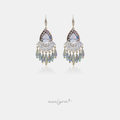 Silver-tone hook earrings with clear pear-shaped crystals above a fringe of iridescent blue-green droplet beads.