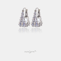 Silver-tone huggie earrings encrusted with crystals cradling a central pearl