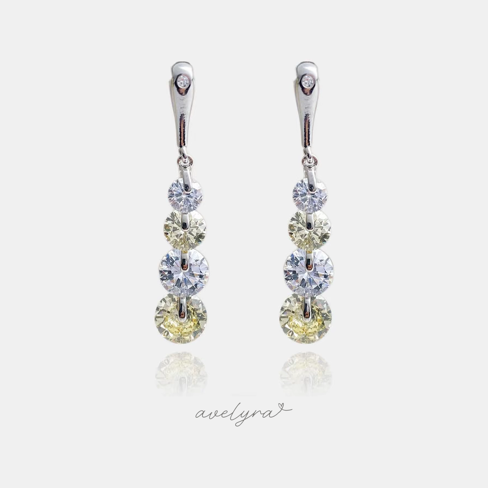 Silver-tone drop earrings with a graduated line of champagne and clear round crystals