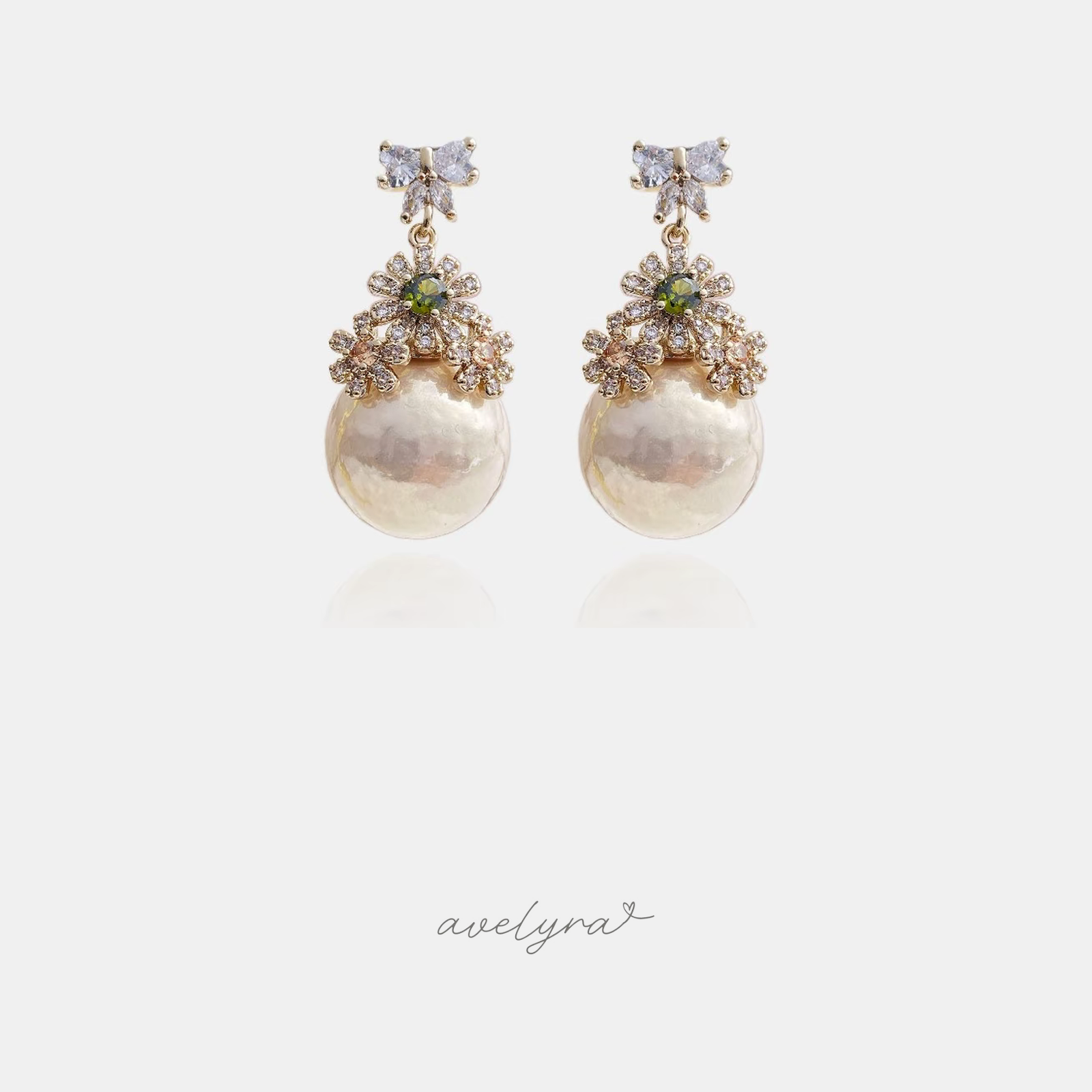 Gold-tone earrings with a crystal butterfly top, floral crystal cluster and a large baroque pearl drop.