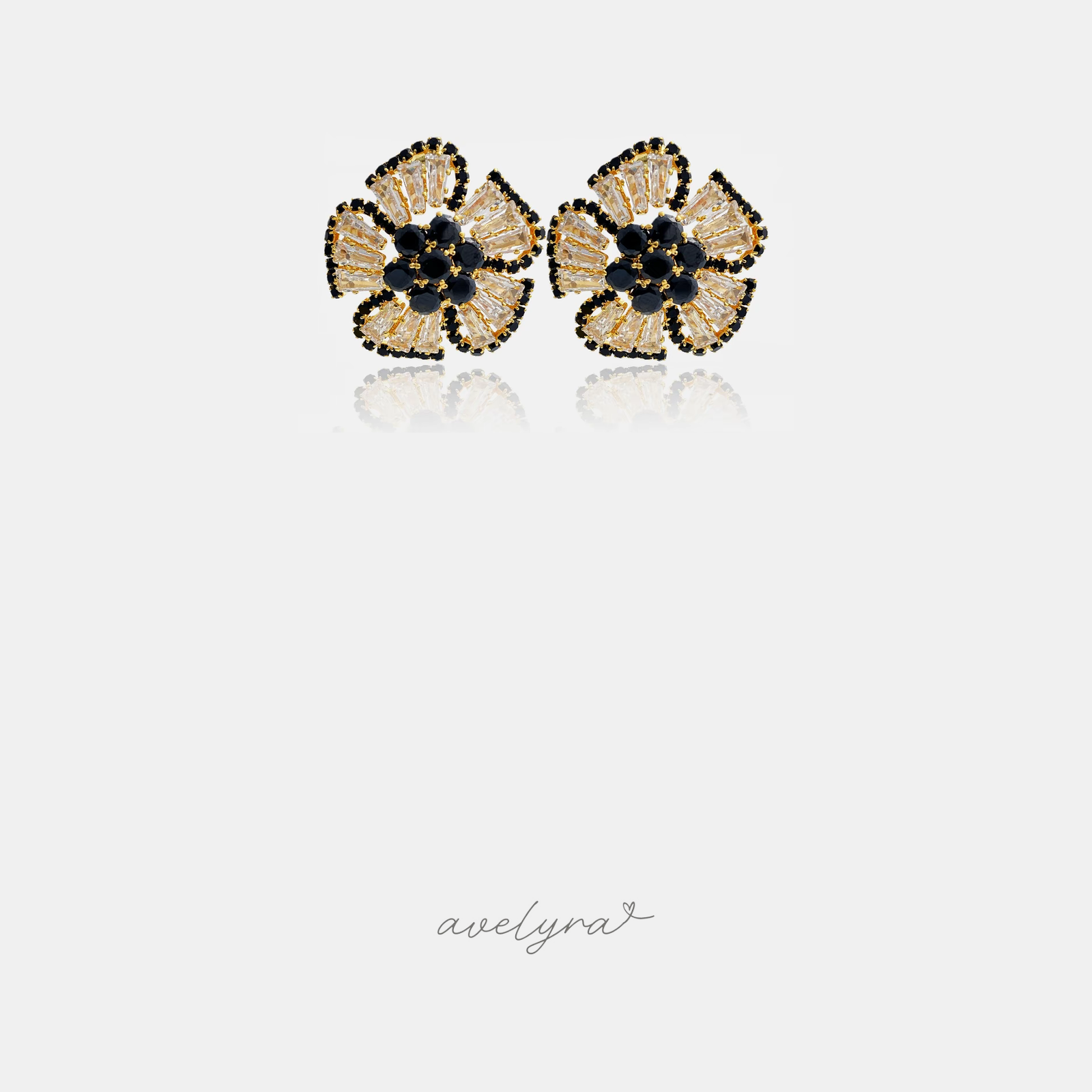 Pair of flower stud earrings with champagne petals outlined in black and a black crystal centre.
