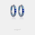 Silver-tone hoop earrings paved in turquoise and dark blue stones with a central cobalt baguette crystal.