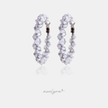 Silver-tone hoop earrings set with clustered clear faceted crystals.