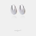 Chunky domed hoop earrings with smooth white surface and silver-tone edges.