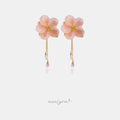 Pink flower earrings with golden centres and thin chains ending in clear and pink crystal droplets.