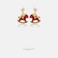 Earrings with a pearl top, small crystal and a red enamel gold-trimmed rocking horse charm.