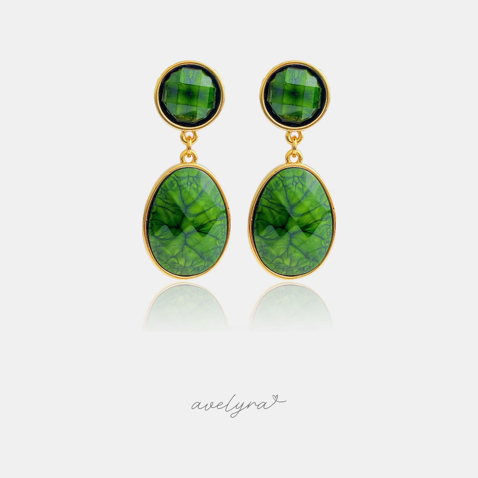 Gold-framed drop earrings with round and oval deep green marbled stones.