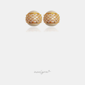 Domed stud earrings with cream pearl-sheen surface and a central band of clear stones in gold prongs.
