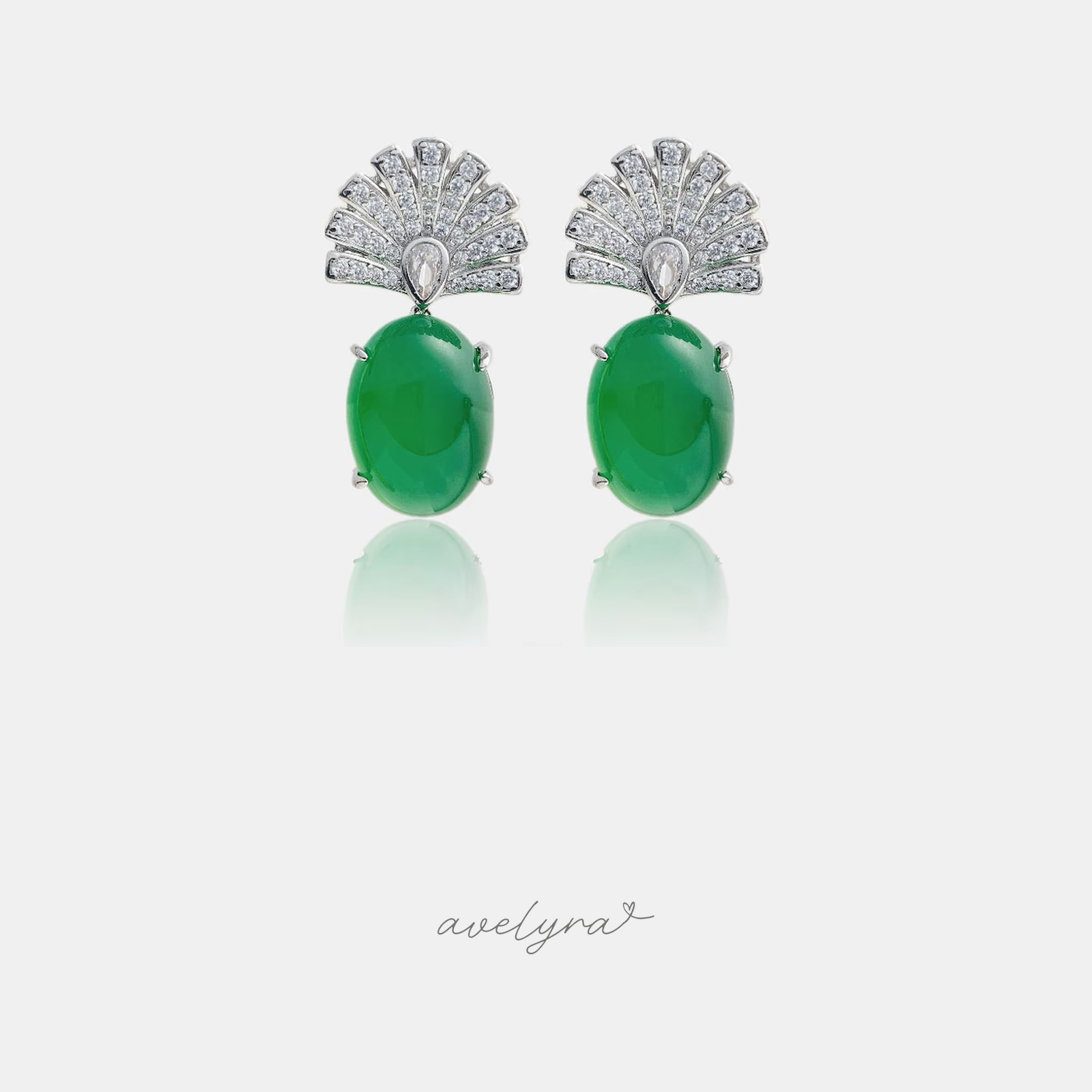 Silver-tone drop earrings with a pave fan top and a smooth green oval cabochon.