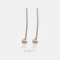 Silver-tone linear drop earrings, a slim line of clear stones ending in a single white pearl.