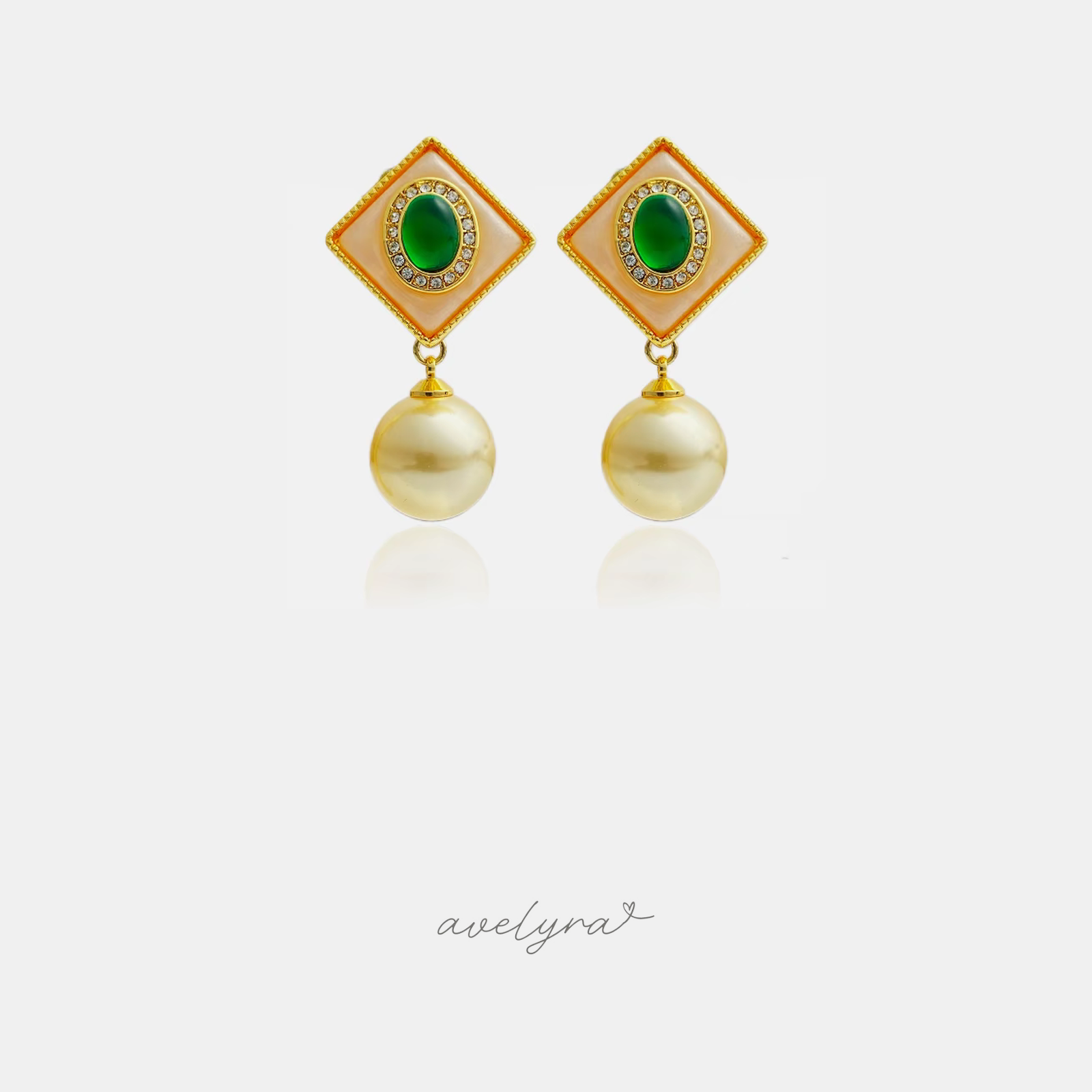 Diamond-shaped earrings with green oval centres and golden pearl drops.