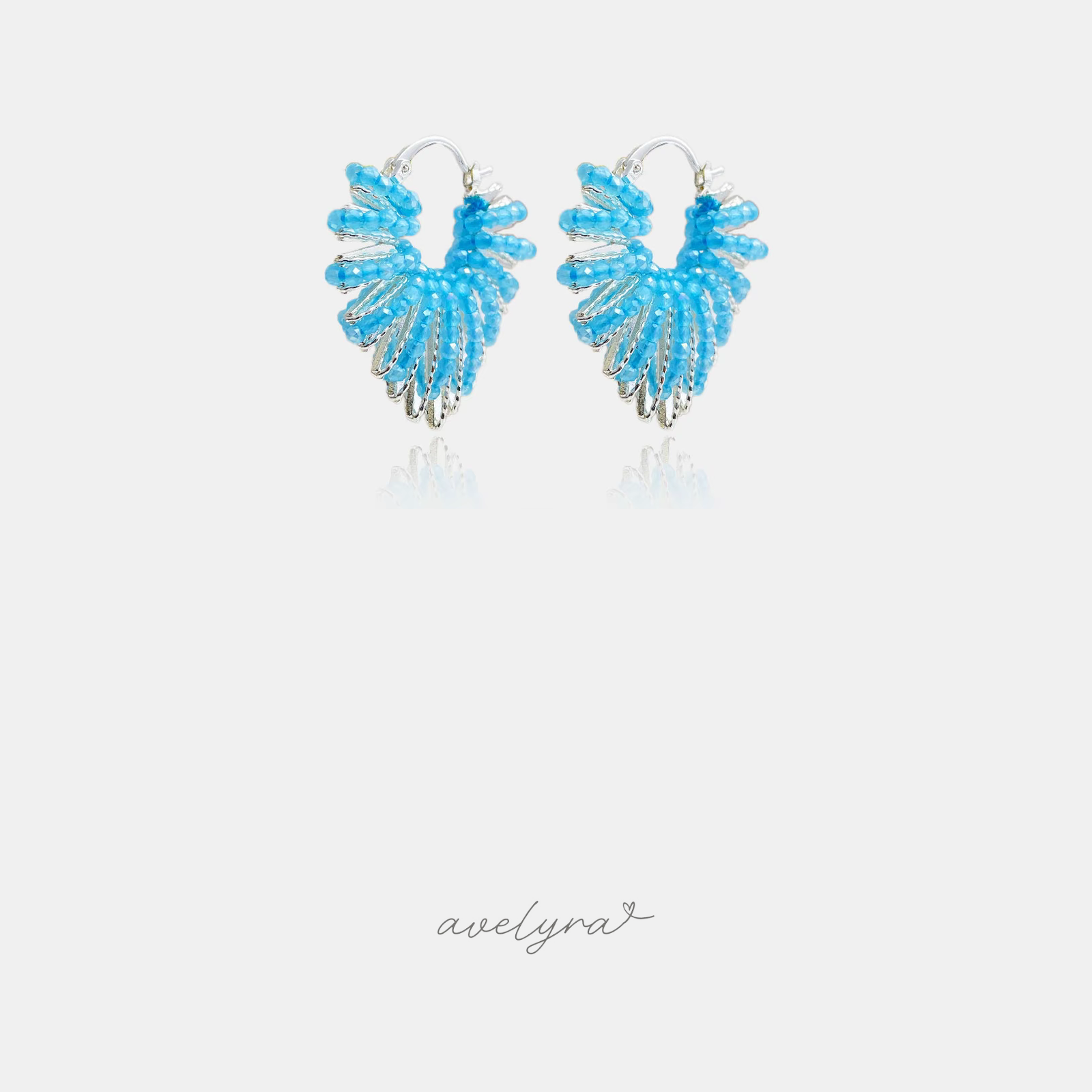 Hoop earrings fanned with rows of sky-blue beads over silver-tone ribs.