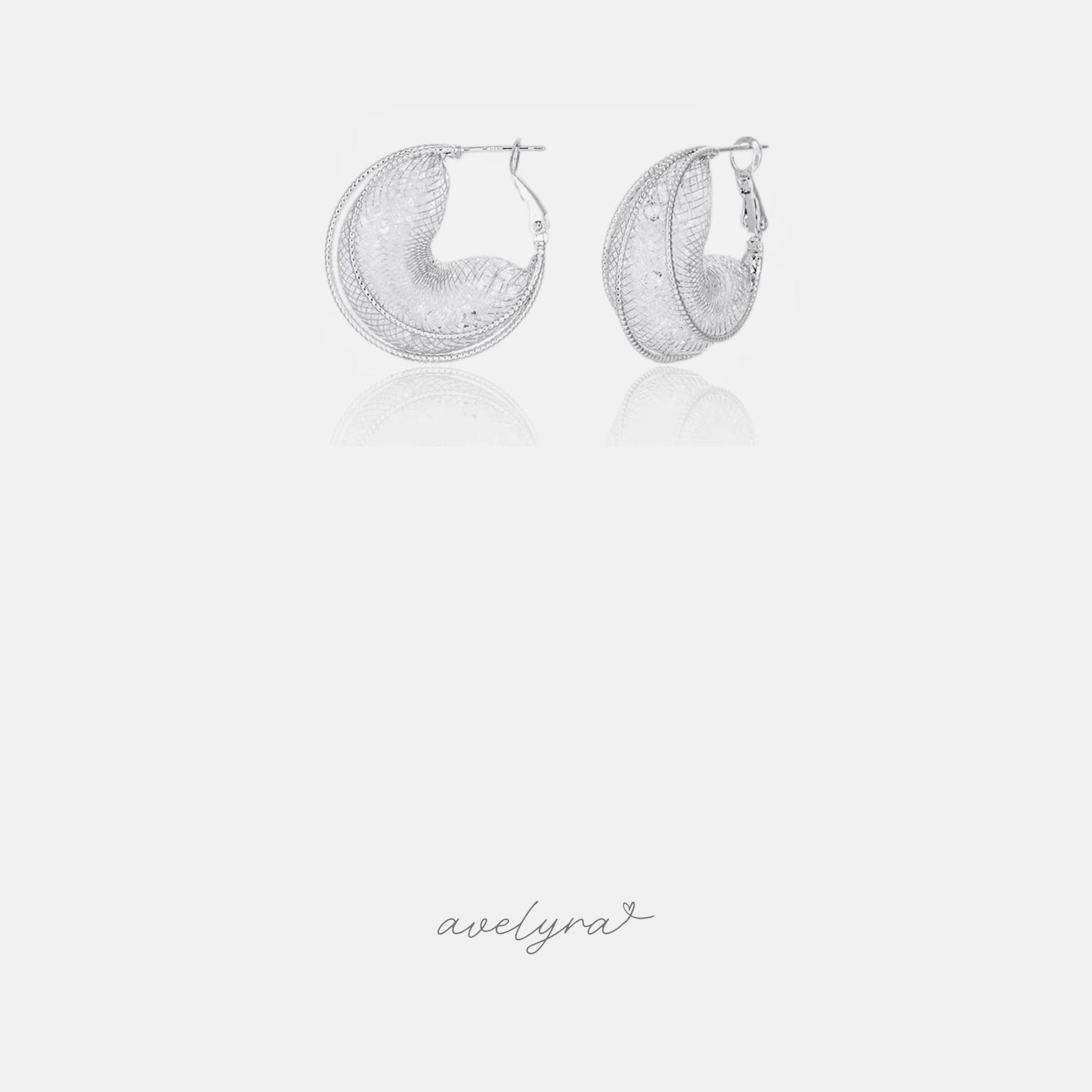 Domed silver-tone hoop earrings made from fine woven mesh.