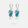 Silver-tone huggie earrings with clustered turquoise and frosted silver beads.