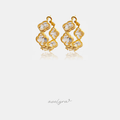 Gold clover-motif hoop earrings set with clear faceted stones.