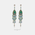 Long green chandelier earrings with a pear-cut green stone and cascading beaded fringe.