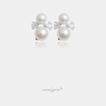 Stud earrings with two white pearls and clear leaf-shaped stones between them.