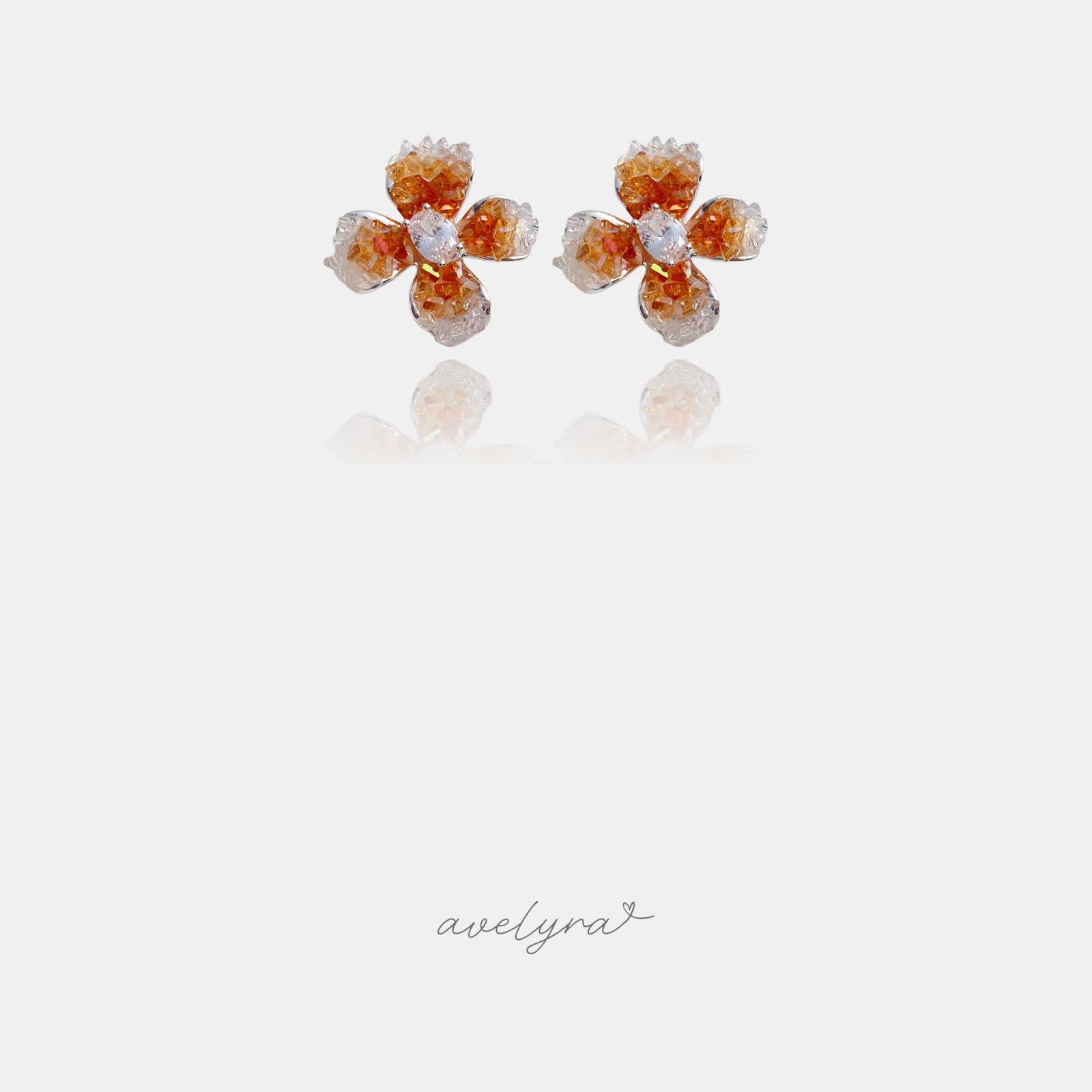 Flower stud earrings with amber and clear crystal beaded petals and a clear oval centre stone.