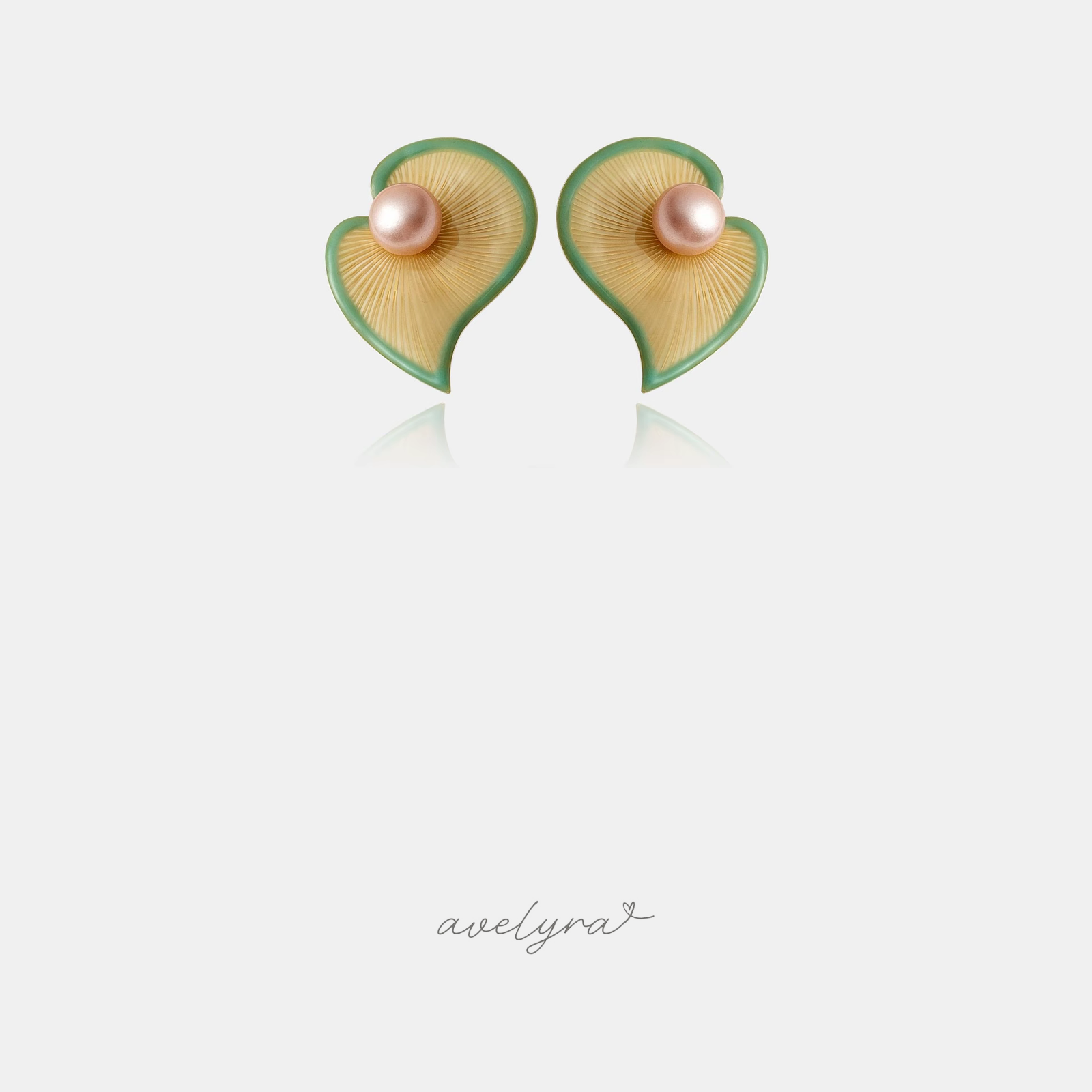 Pair of sculpted heart-shaped petal stud earrings with green edges and a blush pink pearl at the centre.
