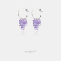 Silver-tone open hoop earrings with a cluster of faceted lilac purple crystals dangling below.