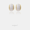 Pair of stud earrings with a smooth milky-white oval stone framed by a gold-tone rim.