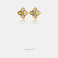 Gold-tone flower stud earrings with pave petals and a square yellow stone at the centre.