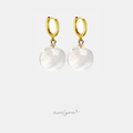 Gold-tone huggie hoop earrings with clear round glass sphere drops.