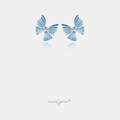 Powder-blue butterfly stud earrings with a clear marquise crystal at the centre.