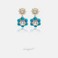 Gold-tone drop earrings with a pearl flower top and turquoise-blue stone flower with crystal centre.