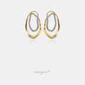 Interlocking organic oval hoop earrings in polished gold-tone and crystal pave silver-tone.