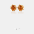 Translucent amber-orange carved rose flower stud earrings.