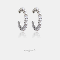 Silver-tone open hoop earrings lined with white pearls and a clear crystal accent.
