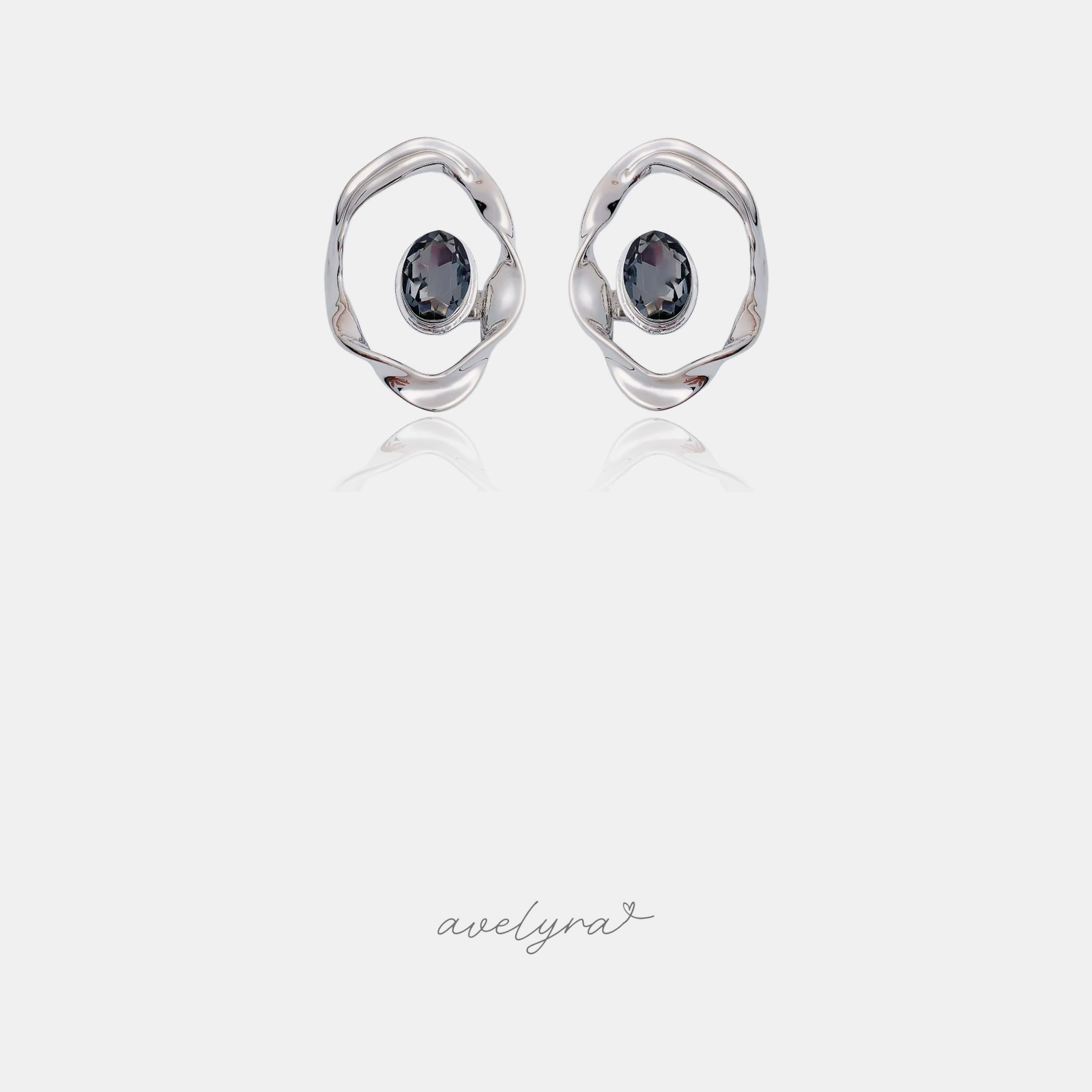 Silver-tone open irregular circle stud earrings with a grey oval stone in the centre.
