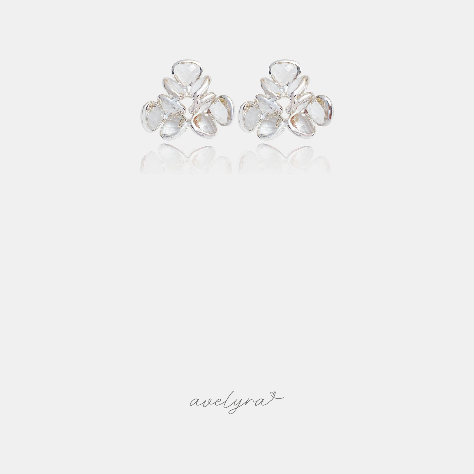 Silver-tone cluster stud earrings made of clear faceted petal-shaped stones.
