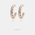 Rose gold-tone open hoop earrings scattered with small clear crystals in star settings.